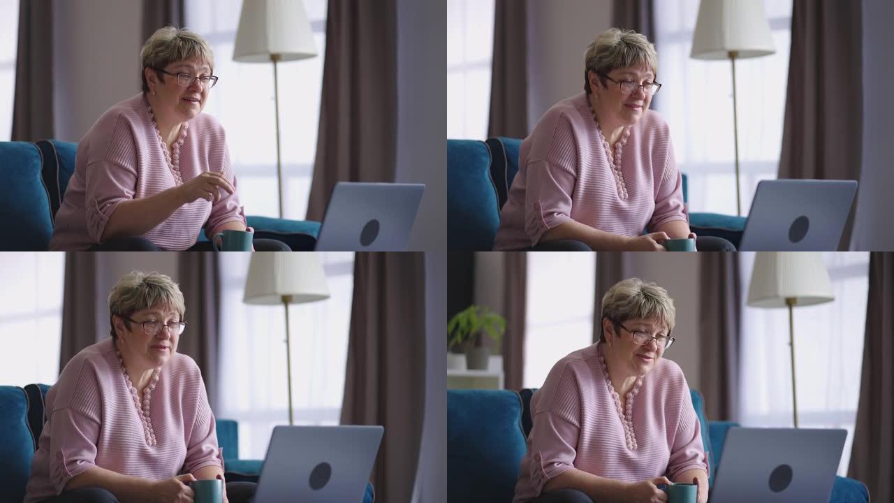 轻松的老年妇女正在通过与朋友的在线视频聊天，女性退休人员正在看着屏幕和网络摄像头进行交流