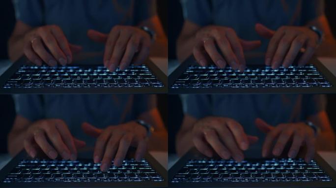 成年男子在夜间使用笔记本电脑，手和键盘的特写视图，上网