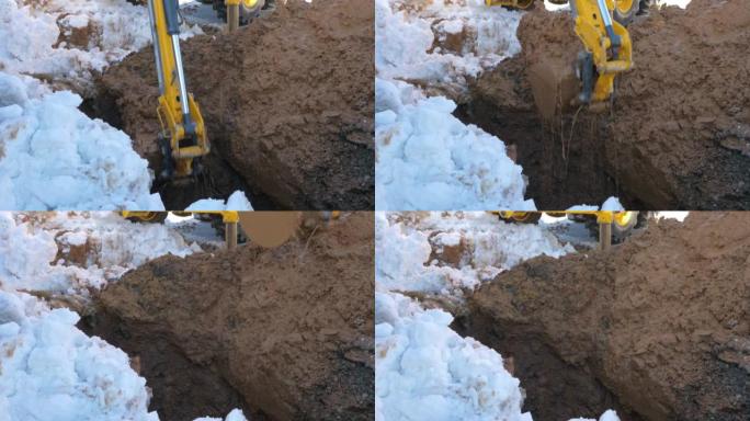 装载机在冬天挖掘潮湿的地面