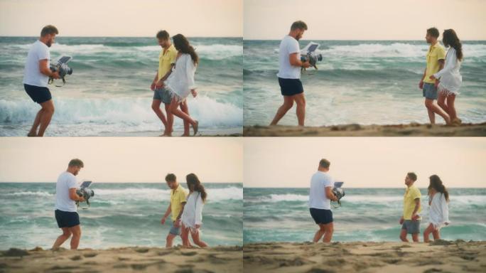 恋爱中的异性浪漫情侣拍摄环节。阳光明媚的日子在海滩上浪漫散步