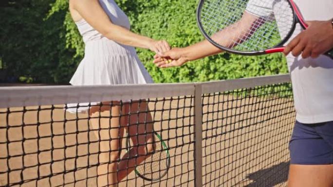 Woman tennis player walks to man and shakes hands 