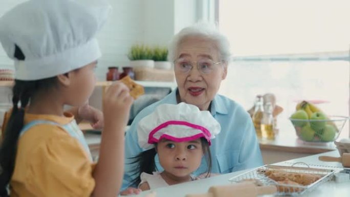 祖母和孙女互相帮助在厨房做面包