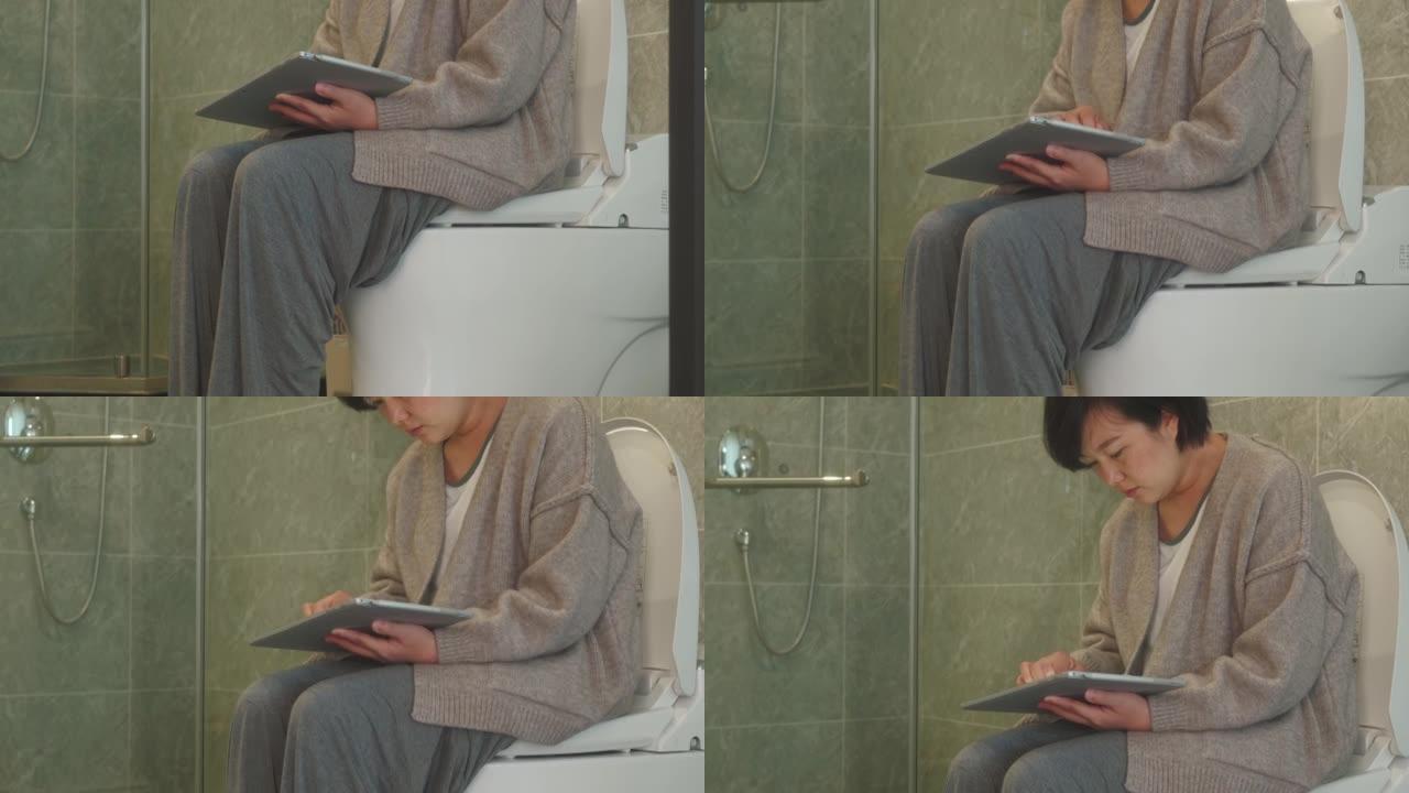 女人在厕所里使用数字平板电脑