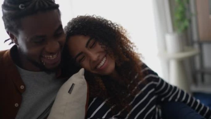 Young couple using the mobile phone at home