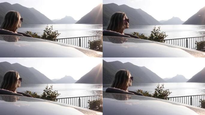 女人从车门望向美丽的湖景