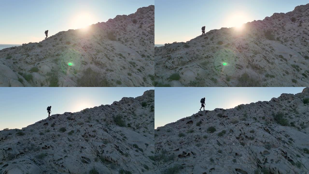 男子在岩石脊顶上徒步旅行的鸟瞰图