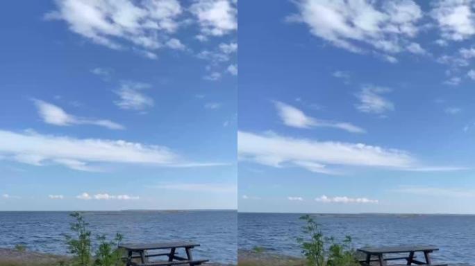 大风天在瑞典群岛户外空野餐桌和长凳的垂直镜头