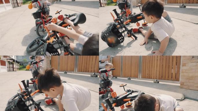 亚洲男孩从自行车上摔下来