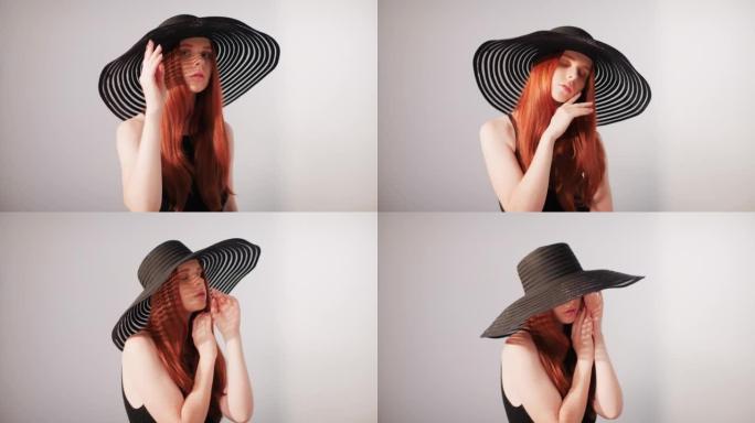 美丽诱人的红发女人对着相机调情。穿着大而优雅的帽子摆姿势，遮住她的脸，抚摸着她的脸