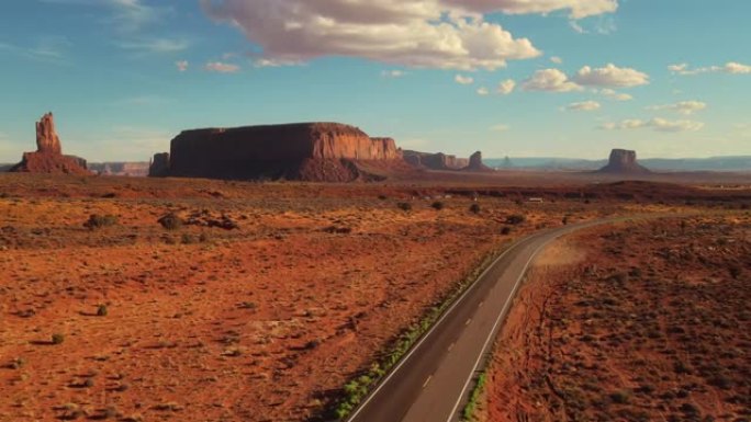 亚利桑那州纪念碑谷的无人机空中飞行视图。纳瓦霍族的红色干旱沙漠和空旷的道路