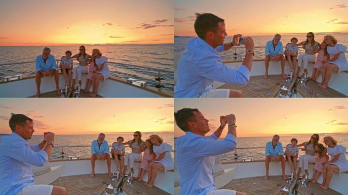 SLO MO Man谈论日落时他的家人在游艇上摆姿势的照片