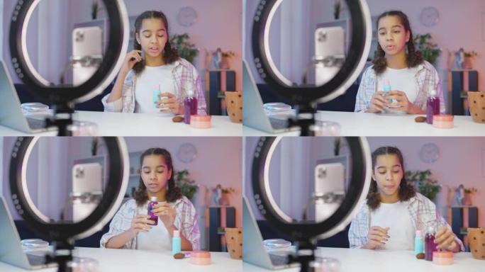 可爱的少女为她的视频博客录制化妆教程