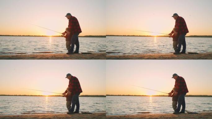 快乐爷爷和小男孩在日落时分钓鱼，老渔夫和孙子在抓鱼