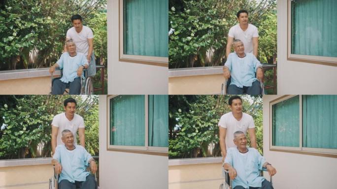 年轻人推着年迈的父亲坐在轮椅上