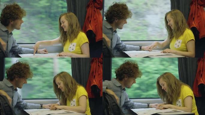 年轻夫妇在乘火车旅行时一起工作