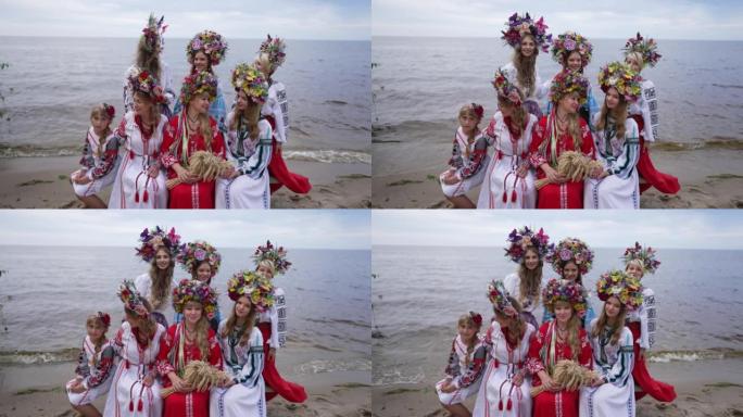 一群乌克兰年轻妇女和女孩坐在沙滩上微笑着环顾四周。穿着花环和传统服装的迷人自信的女士在户外享受春夏。