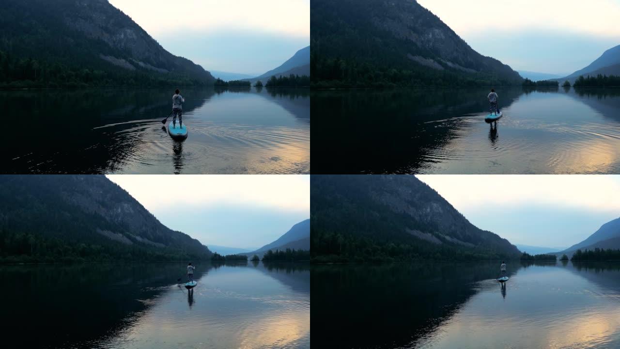 站立桨寄宿生 (SUP) 的鸟瞰图在湖上享受宁静的时光