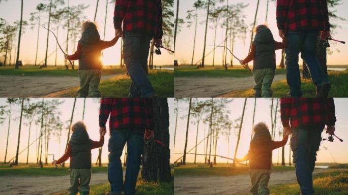 可爱的小孩牵着爷爷或爸爸的手，在日落时分一起散步钓鱼