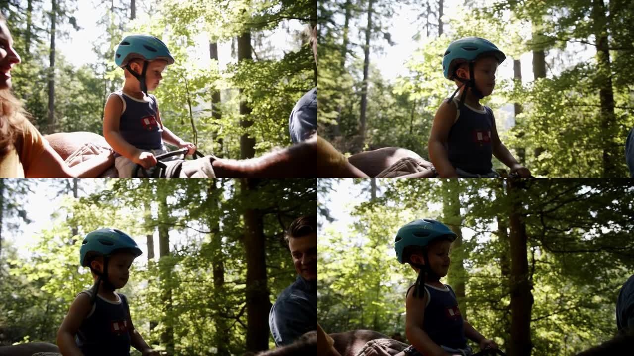 一个小男孩在树林里骑马的细节镜头