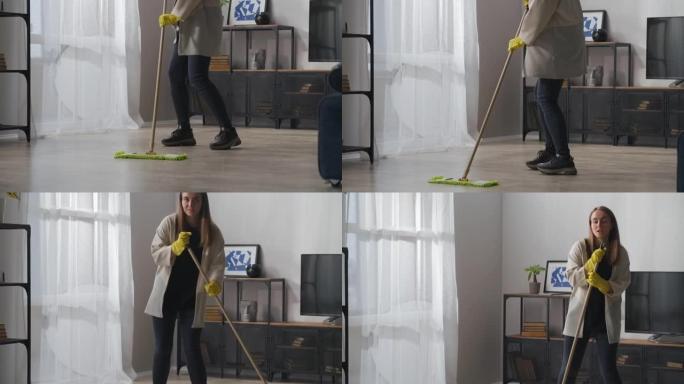 跳舞和唱歌的家庭主妇在客厅用拖把洗地板，周末打扫公寓
