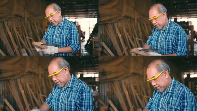 活跃的老年人木匠在闲暇时间用木头工作。