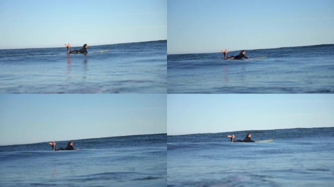 女人在海浪上冲浪，一边微笑一边欣赏风景