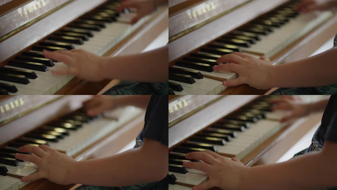 男孩在弹钢琴。家庭教育。双手合十