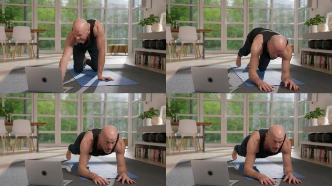 运动男子准备笔记本电脑在家锻炼