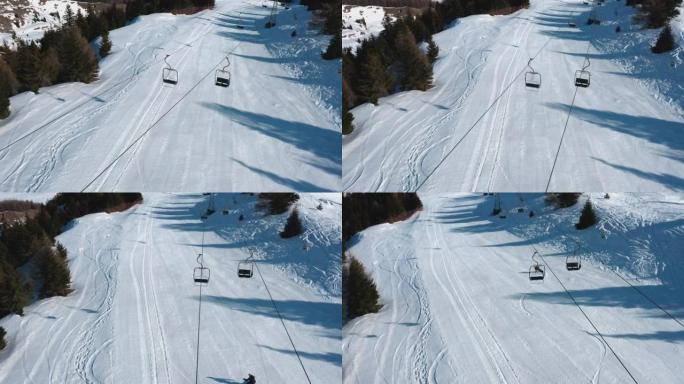 一名滑雪者从山坡上降落的空中无人机拍摄