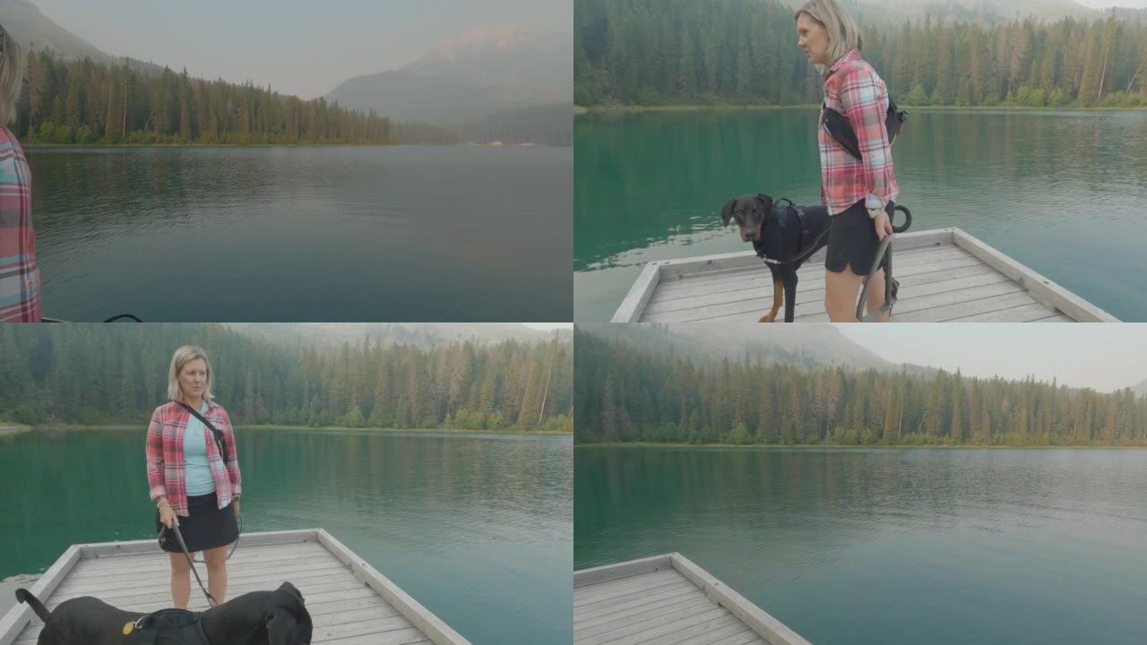 与一名妇女和皮带狗一起观看山中的湖泊