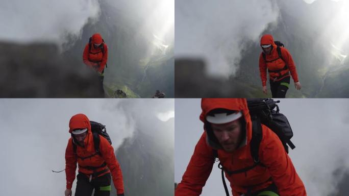 一名男性徒步旅行者带着雨具爬上岩石山腰的特写镜头