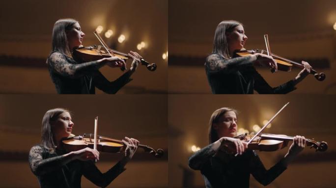 布鲁内特女人在爱乐音乐厅拉小提琴，交响乐团的女音乐家