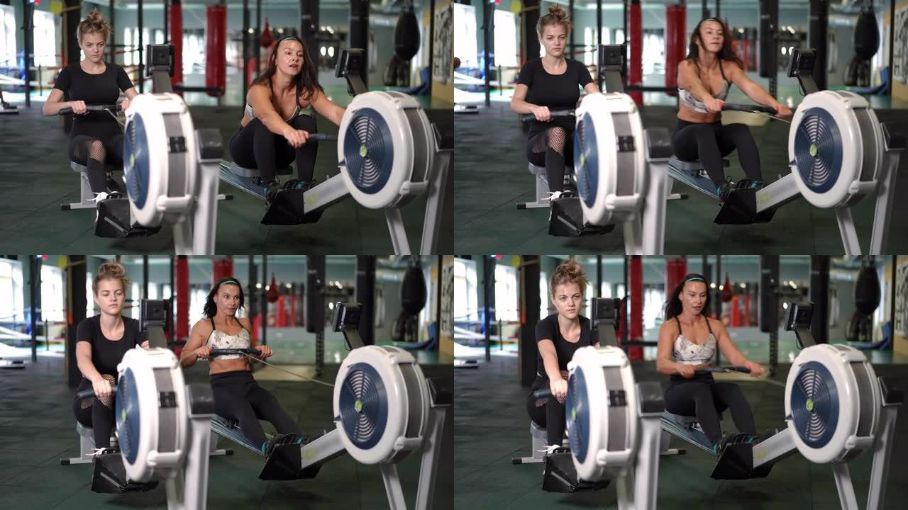 两名自信集中的女运动员在室内健身房拉机上锻炼的宽镜头肖像。运动健康的白人女性在健身房锻炼拉绳训练腿部