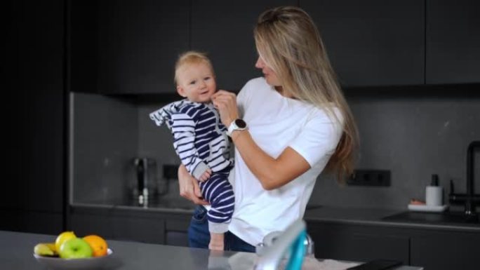 Beautiful woman caressing infant face with feather