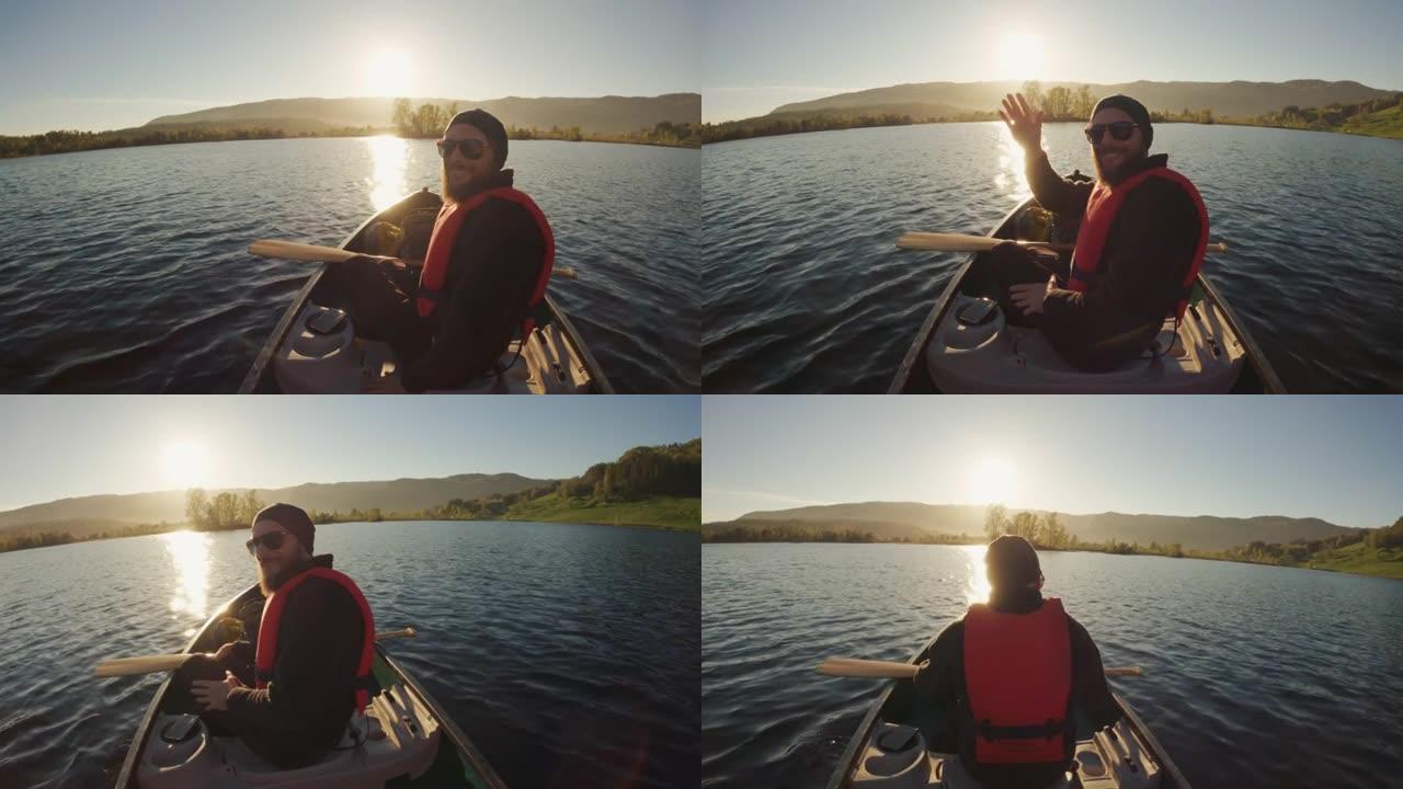 户外冒险: 日落时POV在湖中划独木舟