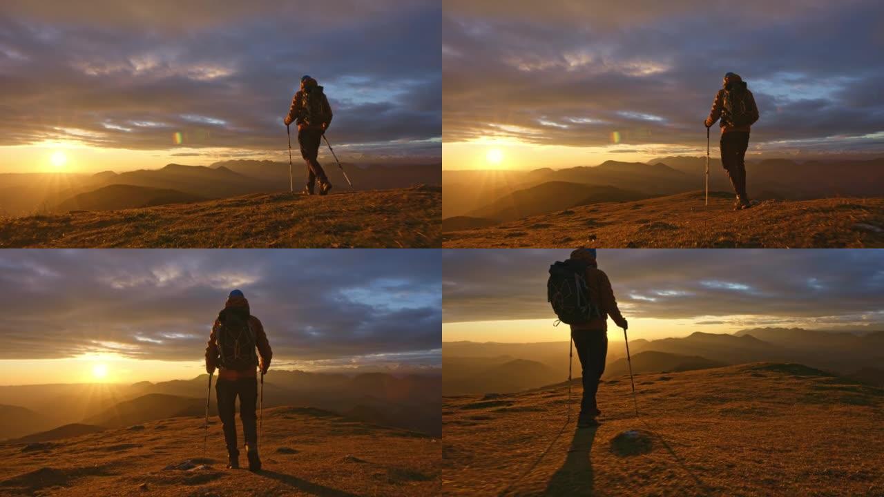 空中SLO MO男徒步旅行者在日落时下山