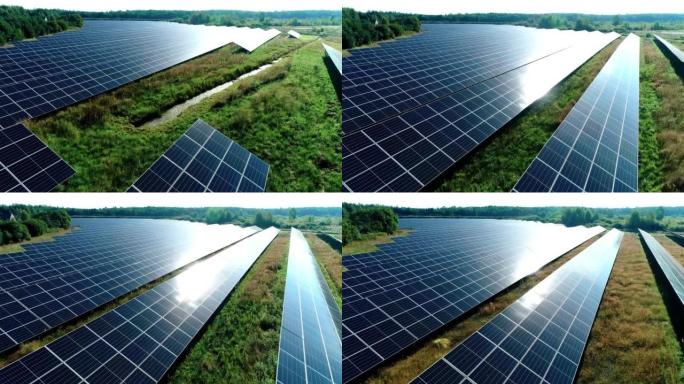 太阳光下太阳能电池板农场 (太阳能电池) 的鸟瞰图。被树木和居民区包围