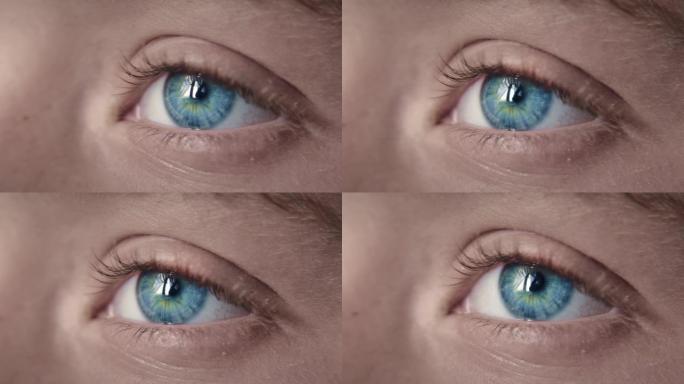 男孩蓝眼睛的极端特写宏观视图。看着相机