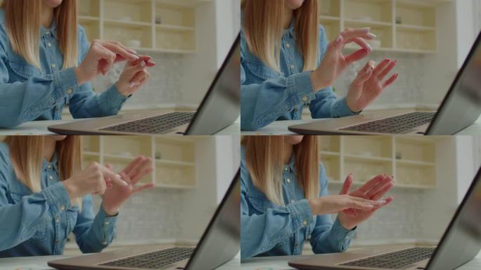 视频通话中女性手与聋人手语交流的特写
