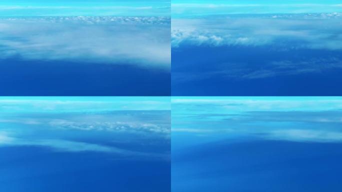 天空上的云，在平静的海面之上。从飞机上观看