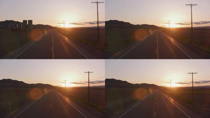 爱达荷州大约2020年。日落时乡村道路的稳定驾驶镜头。用Cineflex万向节和红色8k相机拍摄。