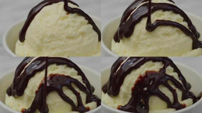 巧克力酱倒在一勺香草冰淇淋上。用红色8k相机拍摄。