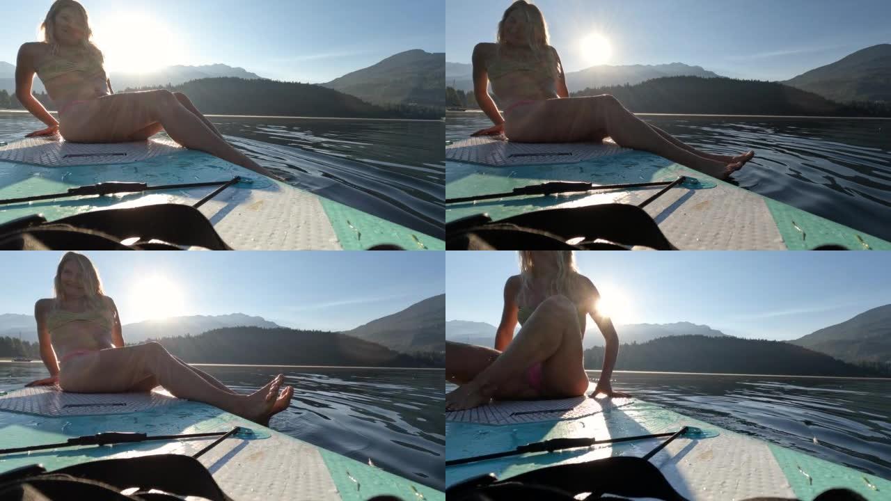 年轻女子在站立桨板上放松的第一人称视角