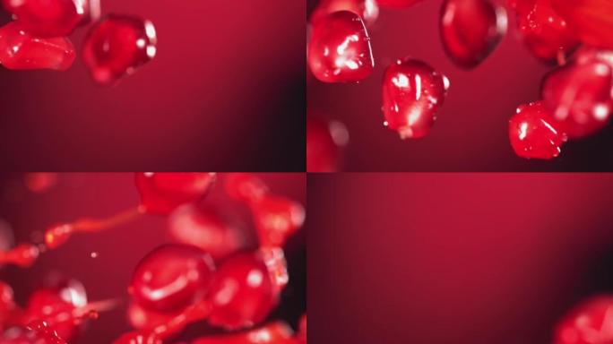 红色背景下新鲜石榴籽与水边碰撞的超慢动作镜头