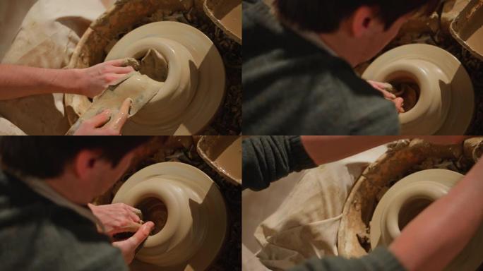 男陶工打开陶工轮子上的粘土