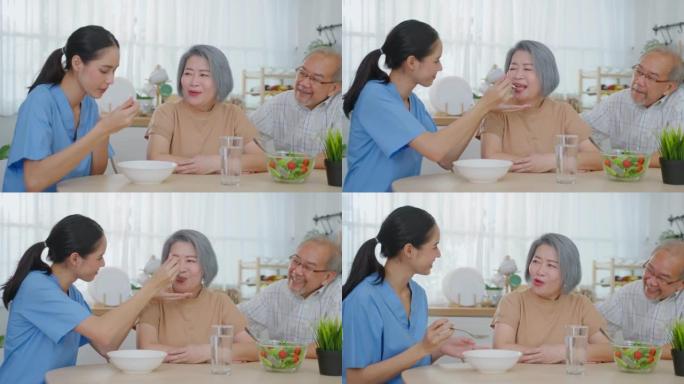 亚洲护理护士为有丈夫的老年女性患者提供食物。有吸引力的年轻专业护理女医生支持和照顾快乐的老年老奶奶在