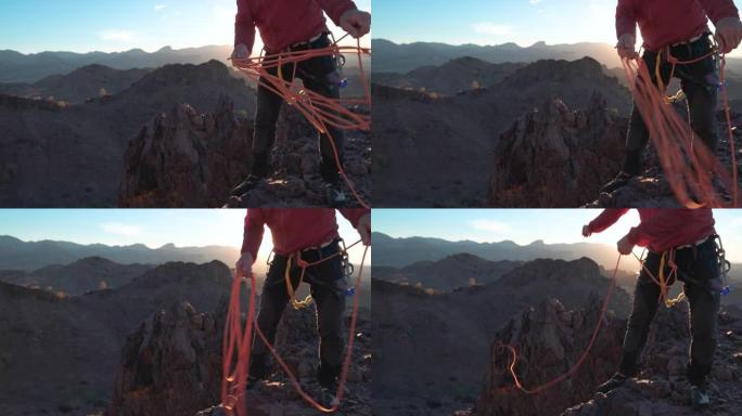 登山者准备在山顶上下降的绳索