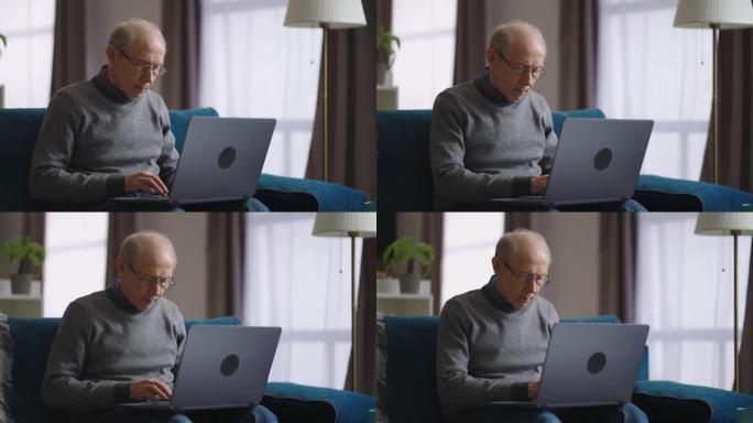老人周末在公寓里用笔记本电脑上网，退休人员在键盘上打字，在社交网络中交流或远程工作