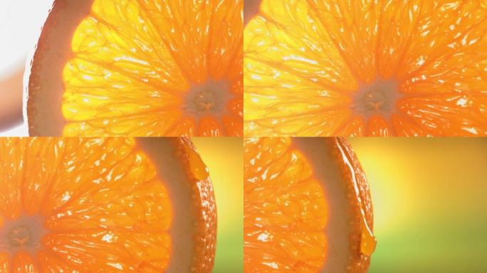 一滴水从成熟多汁的橙色切片的表面流下。慢动作4K