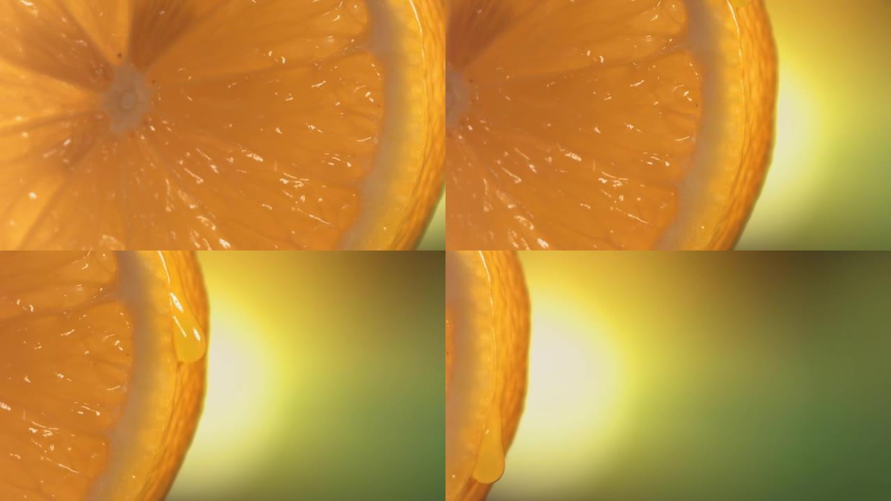 一滴水从成熟多汁的柠檬片表面流下。慢动作4K
